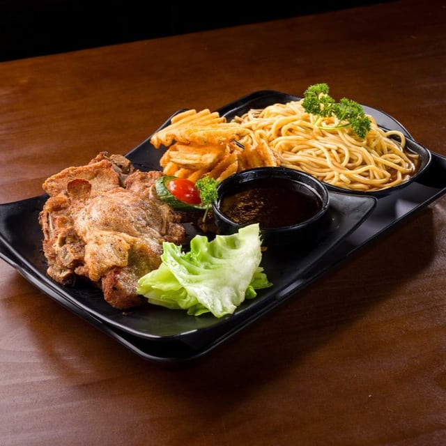 Pan Seared Pork Chop over Spaghetti with Red Sauce.