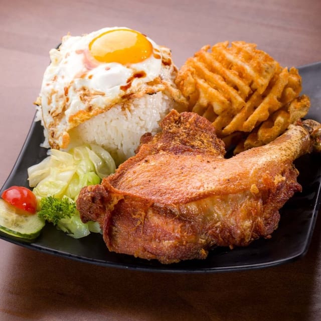 Fried Chicken Leg over Rice with Sunny Side up Egg.