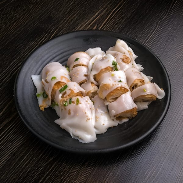 Chan Kee's Chinese fried dough fritters wrapped in rice noodle rolls, garnished with sesame seeds and scallions.