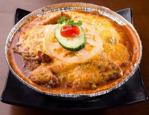 Baked Pork Chop with Cheese Over Rice.